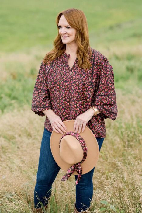 Model wearing the burgundy blouse