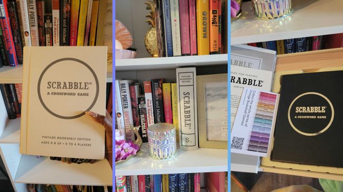 Scrabble game set displayed on shelves surrounded by books and decor, including a candle and a potted plant