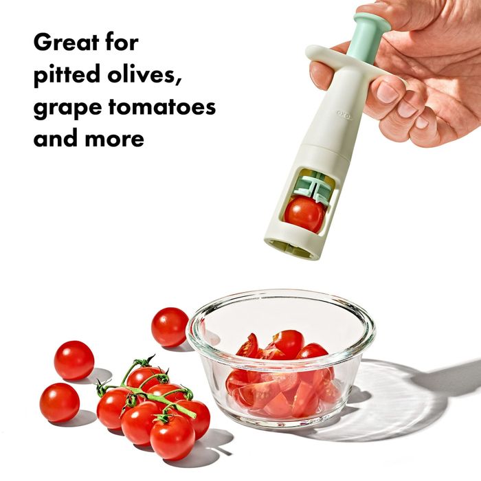 A hand using a kitchen gadget to slice cherry tomatoes into a glass bowl, accompanied by text highlighting its versatility: 