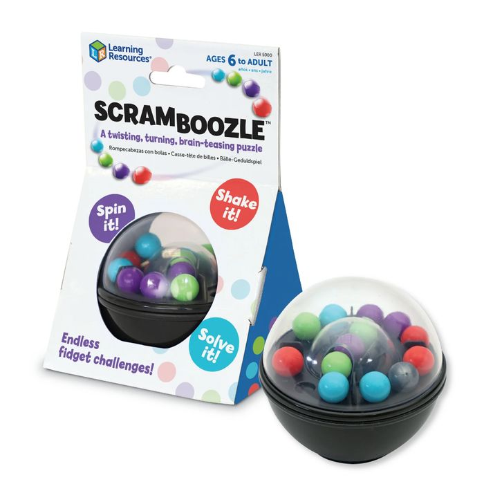 Packaging for a puzzle toy featuring a round container with vibrant balls. Text highlights: "ScramBoozle," "spin it," "shake it," and "solve it."