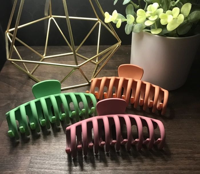 A claw clip in orange, green, and pink.