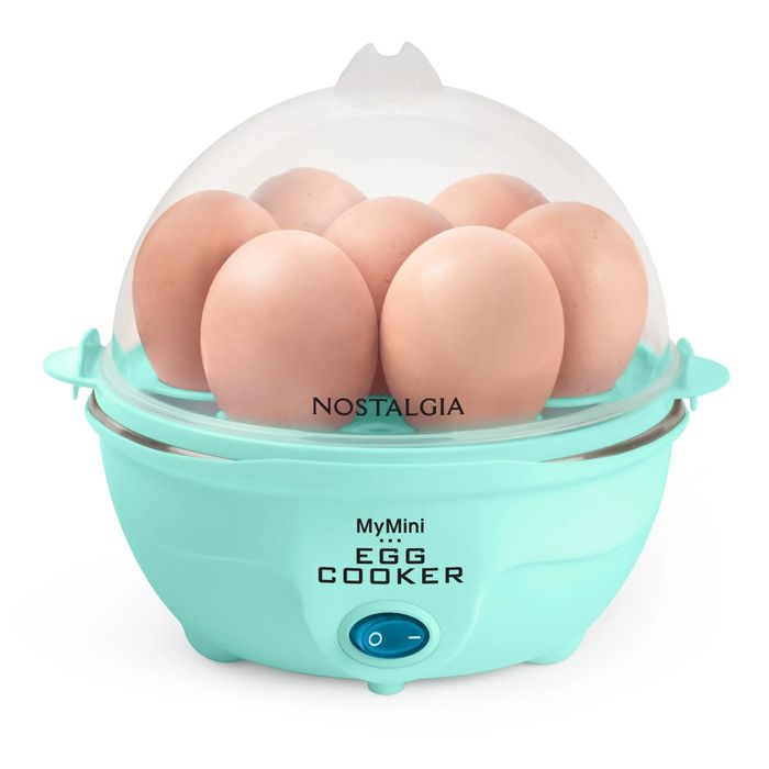 An electric egg cooker with a transparent lid, holding multiple eggs. Labeled "Nostalgia MyMini Egg Cooker," showcased in a shopping feature