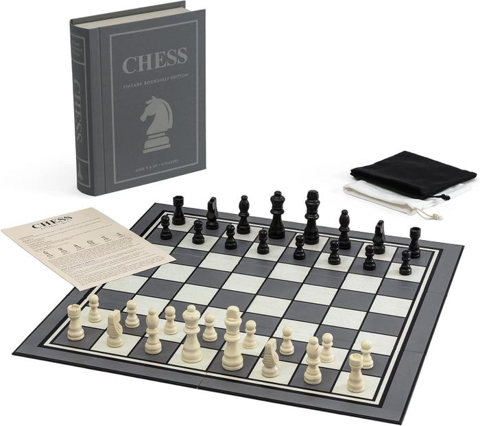 Chess Vintage Bookstyle Edition Game includes a chessboard, black and white chess pieces, a rulebook, and a storage pouch displayed on a flat surface