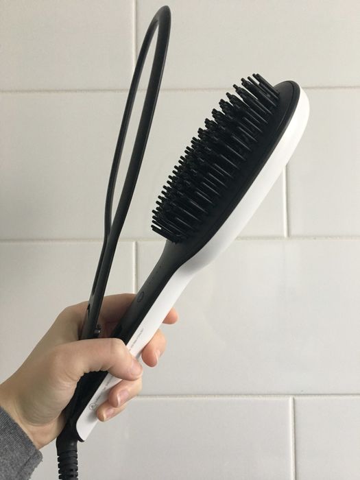A tool featuring both a brush and a clamp.