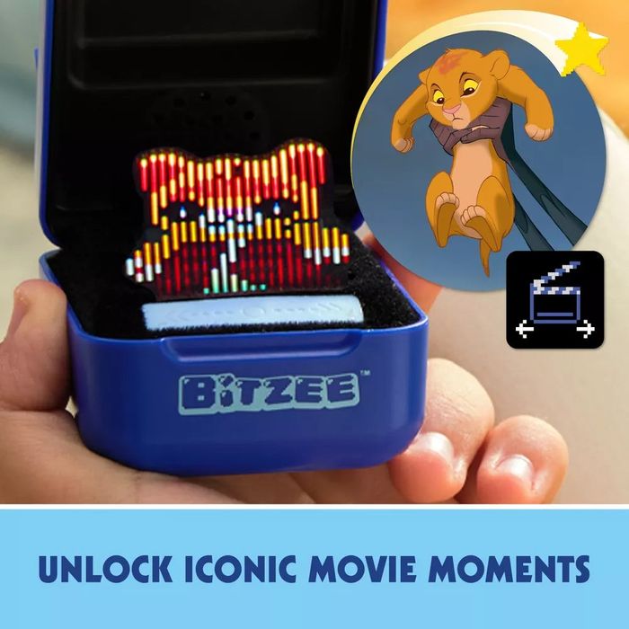 A toy displaying a pixelated image of Simba held in someone’s hand. The text reads: 