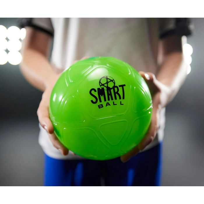 A person holding a green Smart Ball, a high-tech sports gadget designed to monitor ball activity and performance