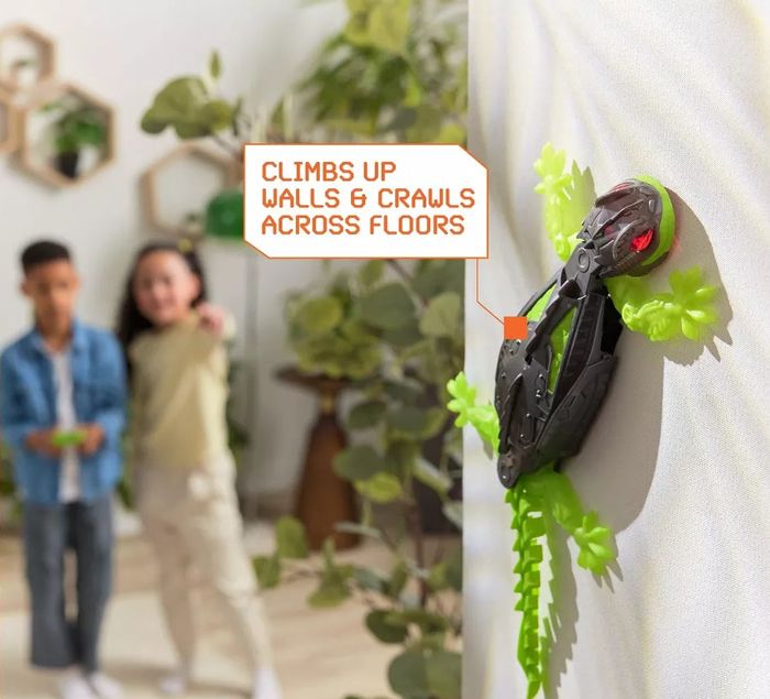 Two kids playing with a robotic lizard toy that climbs walls and moves across floors. The text emphasizes the toy’s ability to spark imaginative play