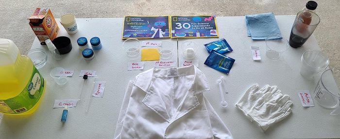 The reviewer’s image of the magic kit, neatly laid out on a surface, complete with a lab coat, gloves, and instructions.