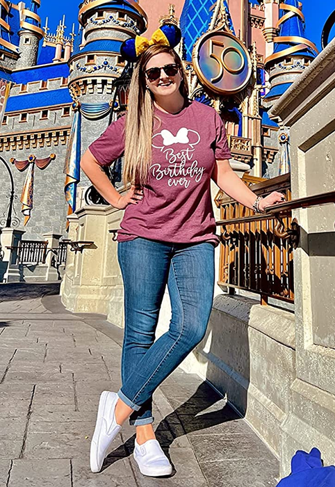 reviewer wearing the white slip-ons at Disney
