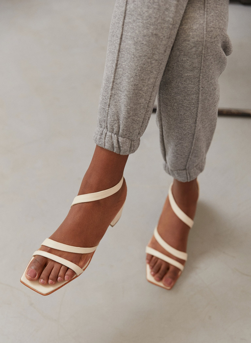 model wearing the white strappy sandals