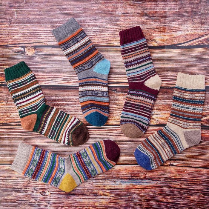 Crew socks featuring muted multicolor stripes in various designs.