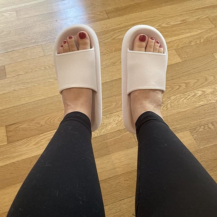 a reviewer wearing black leggings paired with tan open-toed slippers