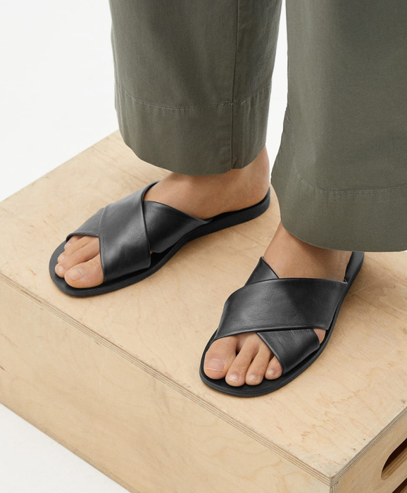 model wearing black crossover slide-on sandals