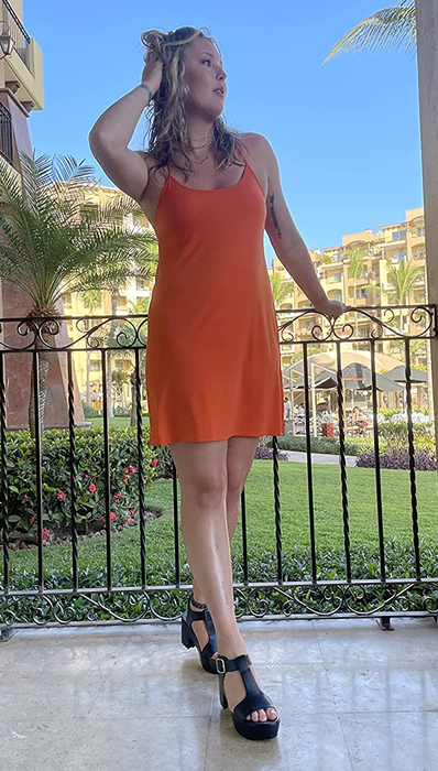 reviewer wearing the black platform sandals paired with a dress
