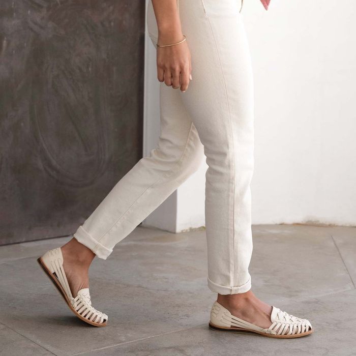 a model showcasing the white version of the shoes
