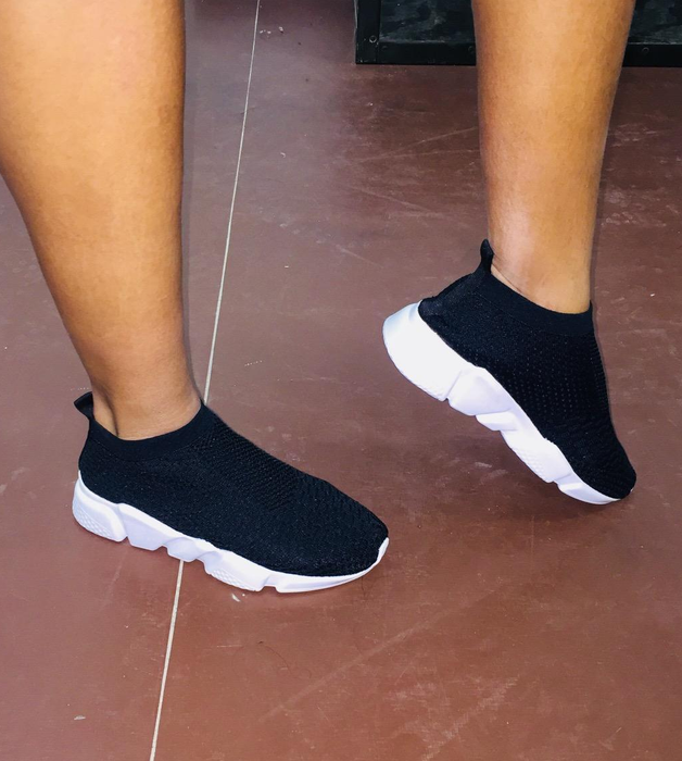 Reviewer wearing the black sneakers