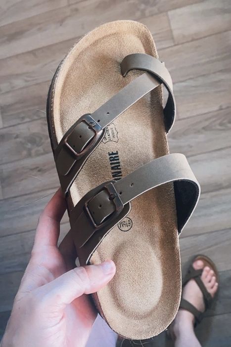 a reviewer holding one of the sandals