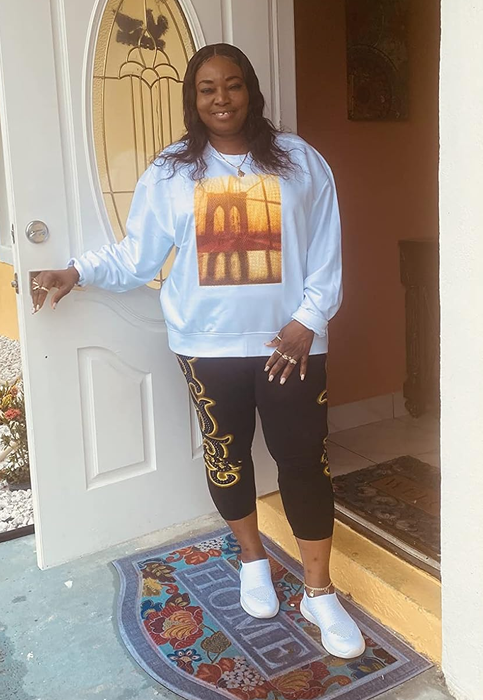 reviewer wearing the white knit sneakers