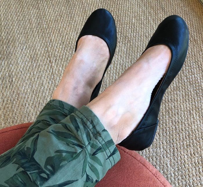 a photo of a reviewer’s feet in green pants paired with black ballet flats