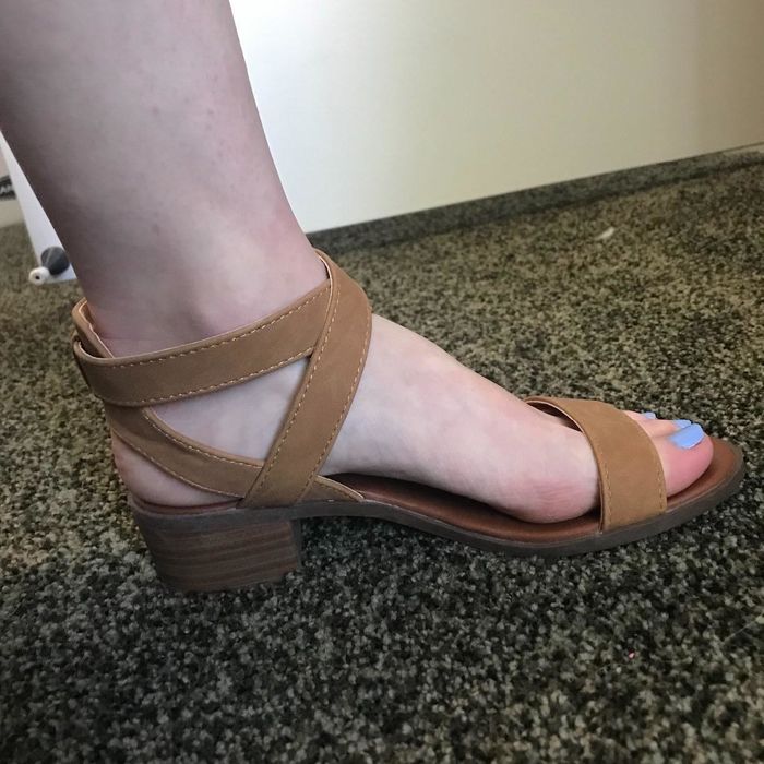 a reviewer wearing the brown version of the sandals