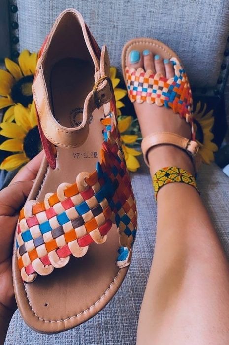 a model wearing the vibrant rainbow sandals
