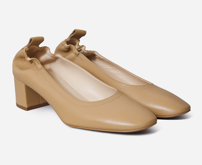 a pair of the identical shoes in a tan color