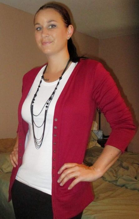 A reviewer showcasing the cardigan in red.