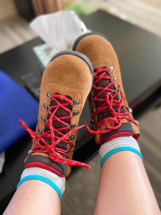 Tan hiking boots with red shoelaces