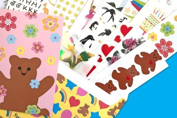 Animal, food, flower, ballerina, star, heart, and letter sticker sheets spilling out of a decorated envelope.