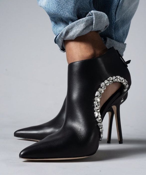black heeled pointy toe shoes with a cutout on the side lined with stones