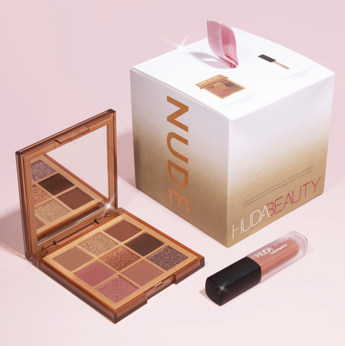 A square eyeshadow palette featuring nine shades, a mirror, the box, and a lipstick.