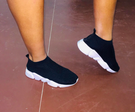 Reviewer rocking black sneakers