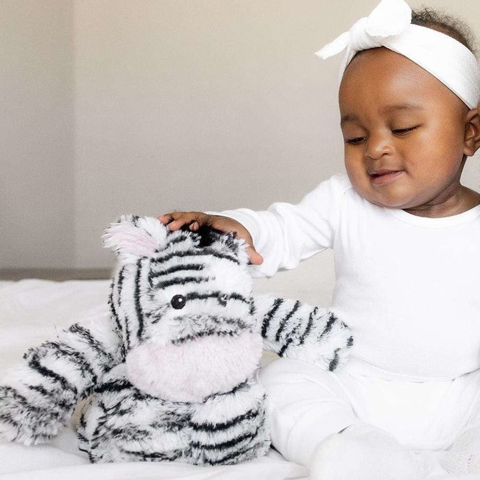 a baby with a plush zebra