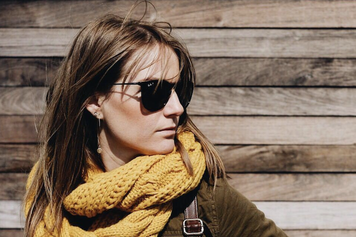 a reviewer sporting the yellow scarf paired with sunglasses