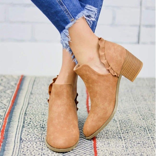 model wearing brown ruffle boots with jeans