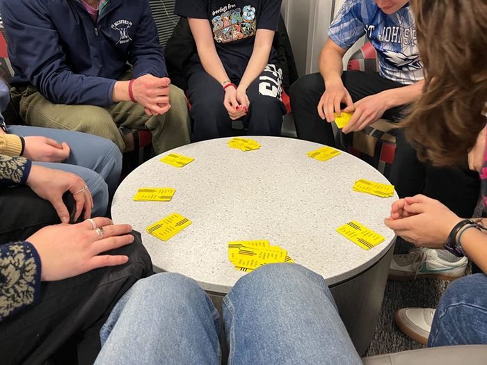 A reviewer and their friends enjoying the game together at a round table