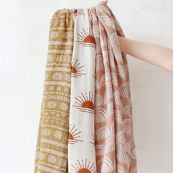 Three swaddles displayed, each featuring a unique pattern