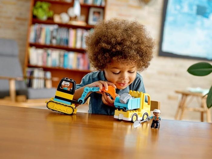 a child having fun with the truck set