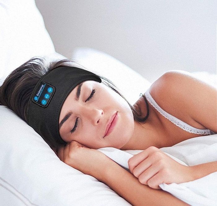 a model lying on their side, wearing the headband