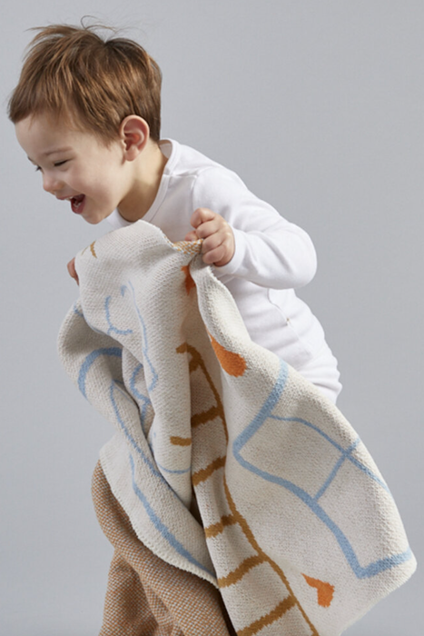 A child playing with the blanket
