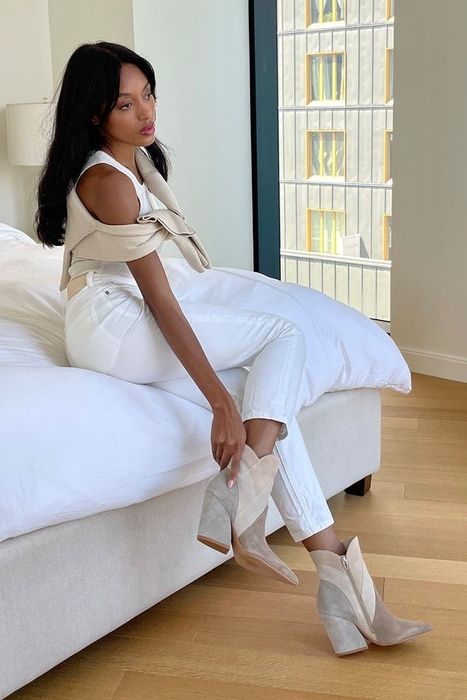 a model wearing the neutral colorblock boots