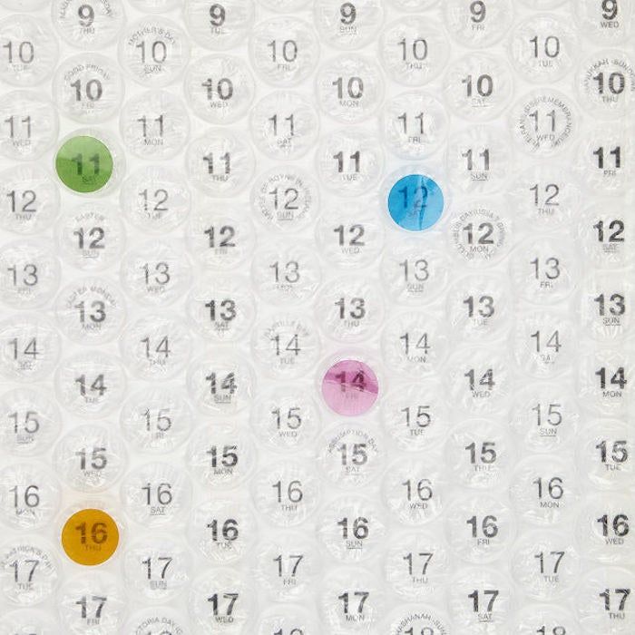 A close-up view of the calendar, showing a few bubbles already popped, adding some fun to the day-to-day.