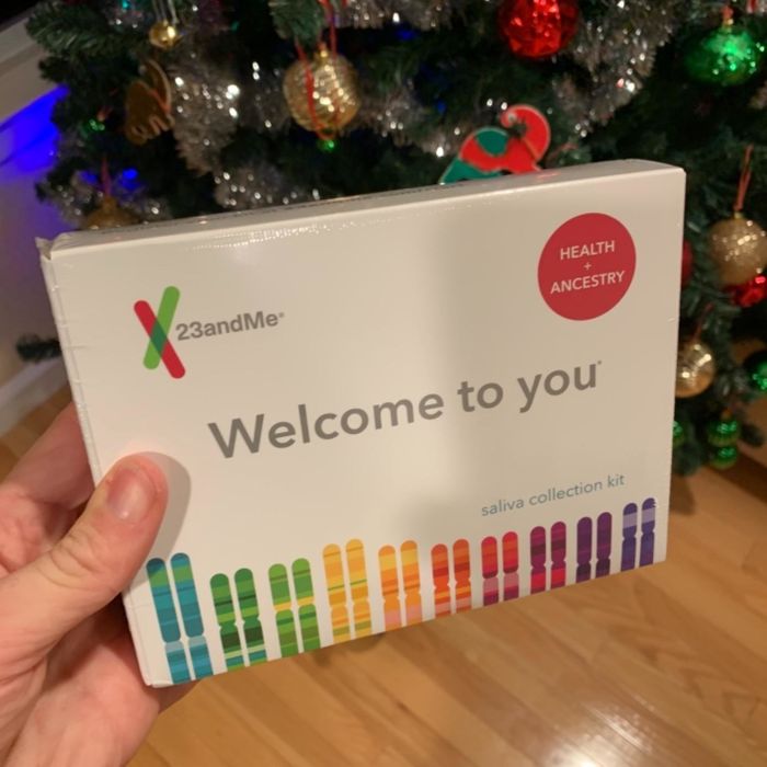 A reviewer holding the kit in front of a Christmas tree