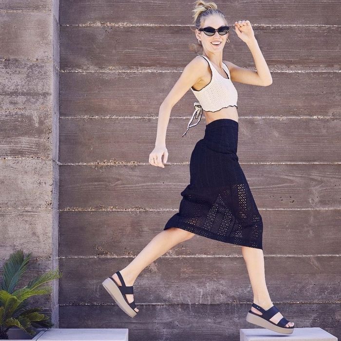 A model showcasing the sandals in black.