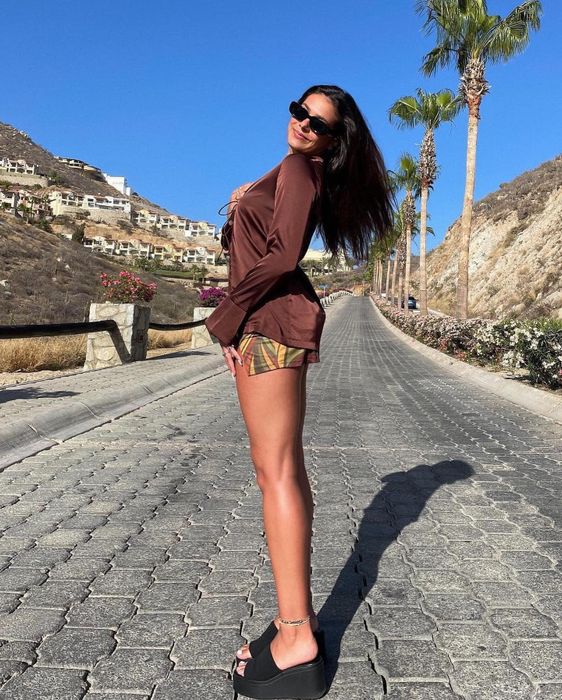 A model sporting the black version of the platform sandals.