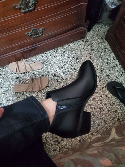 black heeled boot with a zipper on the side