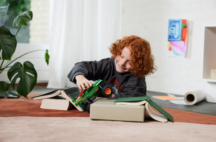 A child plays with a Monster Truck toy.