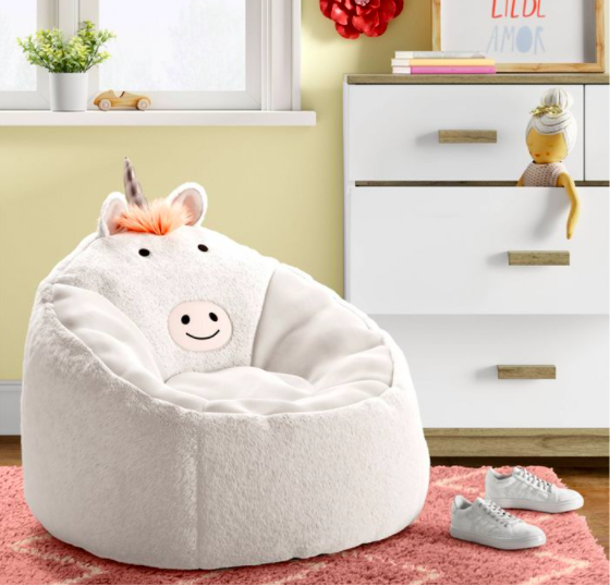 a white plush chair featuring a unicorn face and horn