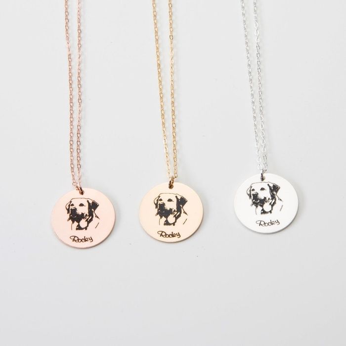 A necklace featuring Rocky the dog's portrait, available in rose, gold, and silver finishes