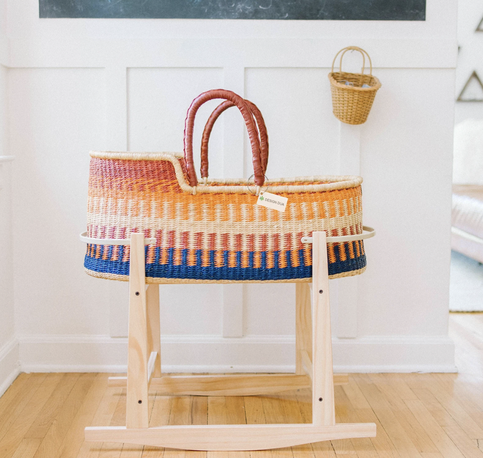 The same bassinet in color, now placed on a rocking stand